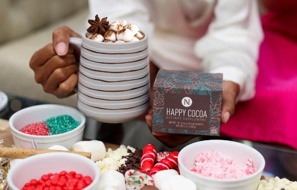 A lifestyle shot of the Happy Cocoa in a mug.