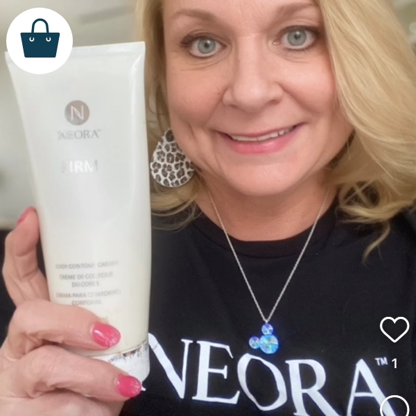 Woman smiling and holding Neora’s Firm Body Contour Cream.